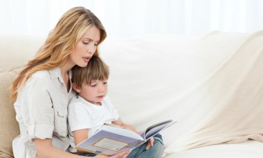 Mother reading with her son clipart