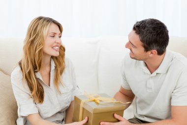 Man offering a gift to his wife clipart