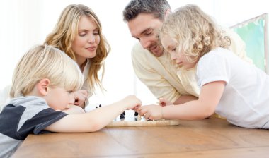 Family playing chess on a table clipart