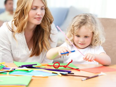 Woman and her daughter cutting paper clipart