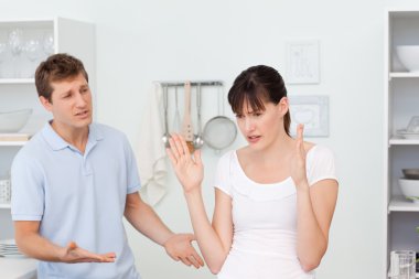 Young lovers having dispute in the kitchen clipart