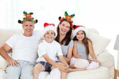 Family during Christmas day looking at the camera clipart