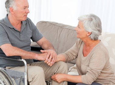 Woman with her husband in a wheelchair clipart