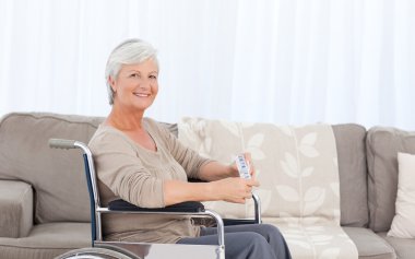 Woman looking at the camera in her wheelchair clipart