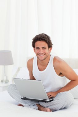 Man working on his laptop at home clipart