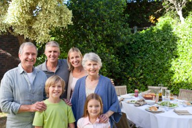 Portrait of a joyful family looking at the camera clipart