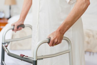 Senior woman with her zimmer frame clipart