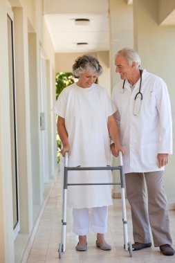 Doctor walking with his patient clipart