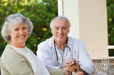 Senior doctor talking with his mature patient clipart