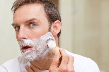 Man shaving in the bathroom clipart