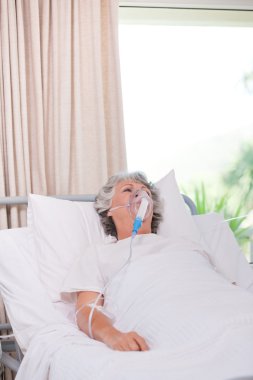 Senior woman with her respirator clipart