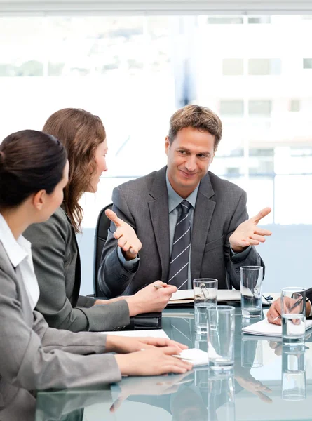 Happy chef talar till hans team som sitter vid ett bord — Stockfoto