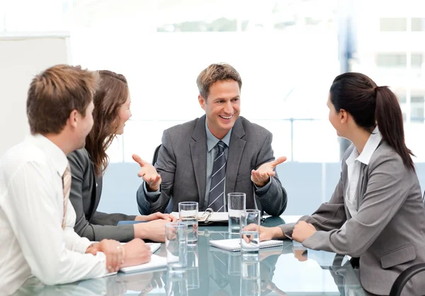 Cheeful manager talking to his team at a meeting — Stock Photo, Image