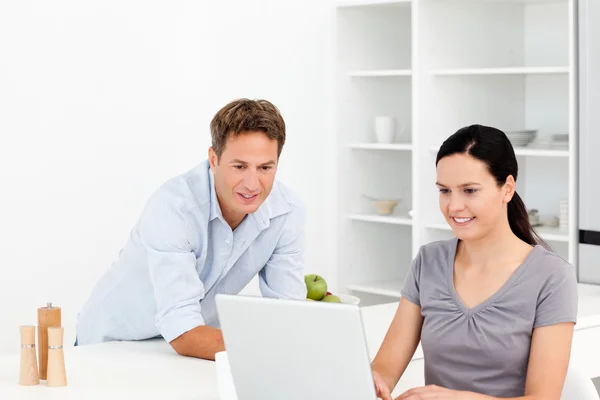 Attentive couple working together on the laptop in the kitchen — Stock Photo, Image