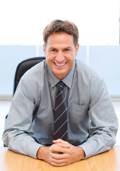 Happy manager sitting at a table — Stock Photo, Image
