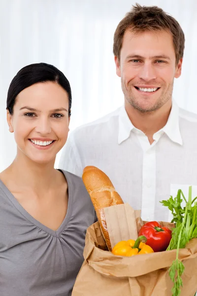 Portrait of a happy couple at home after shopping — Stock Photo, Image