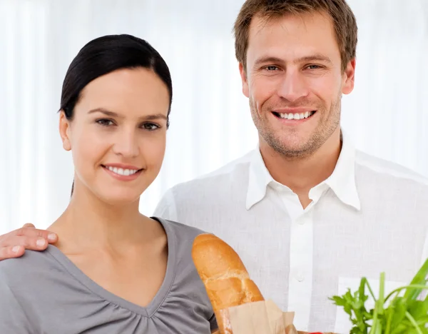 Retrato de una pareja encantadora en h cocina después de ir de compras — Foto de Stock