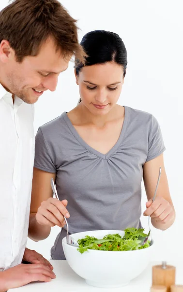 Cute couple preparing a salad together — Stock Photo, Image