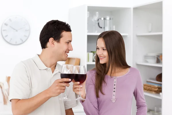 Lovely couple giving a toast with red wine — Stock Photo, Image