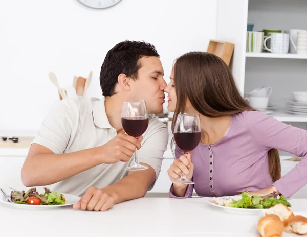 Cute couple giving a toast while having lunch — Stock Photo, Image