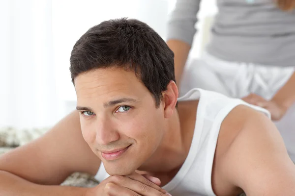 Portrait of a happy man being massaged by his girlfriend — Stock Photo, Image