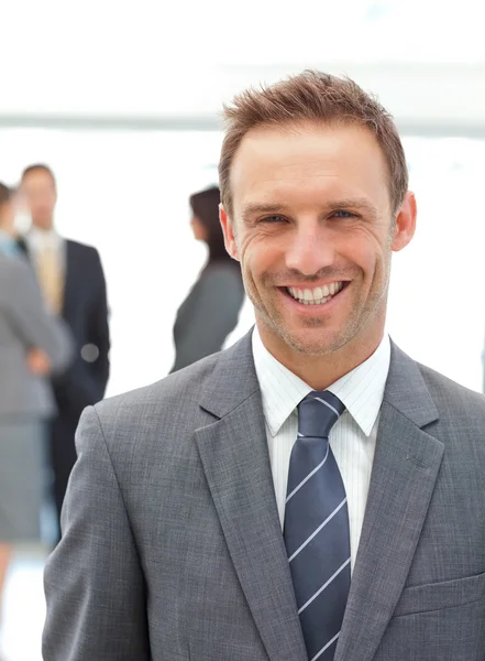 Happy manager standing in front of his team — Stock Photo, Image