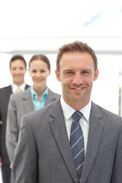 Three happy business posing in a row — Stock Photo, Image