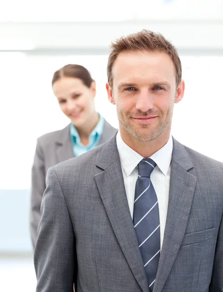 Two smiling business posing in a row — Stock Photo, Image