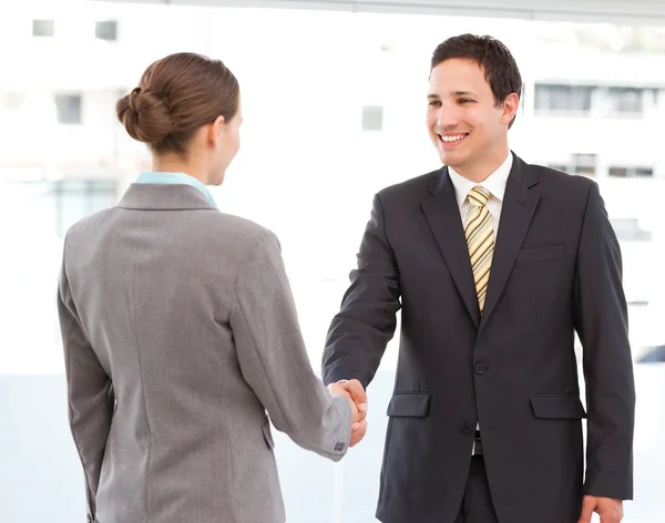 Cheerful businessman and businesswoman concluding a deal — Stock Photo, Image