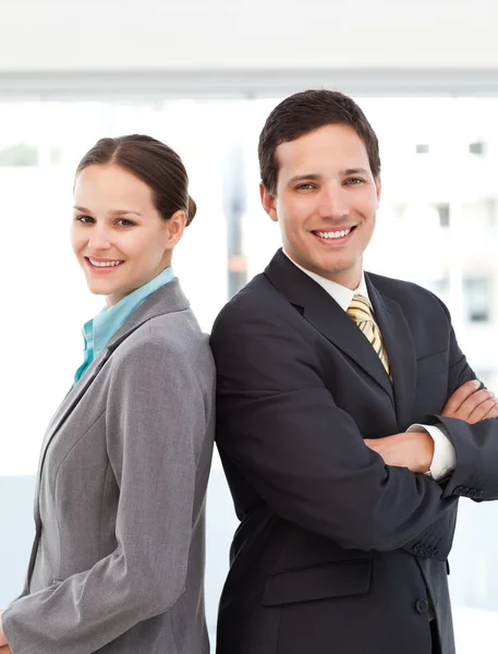 Happy businessman and businesswoman posing back to back — Stock Photo, Image
