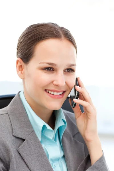 Pretty businesswoman with her cellphone at her desk — Stock Photo, Image