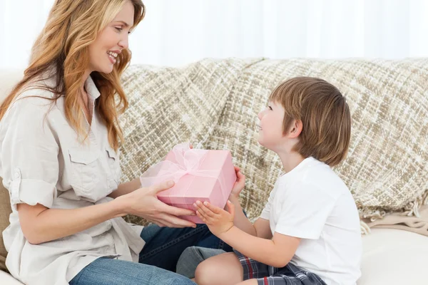 Mother offering present to her son — Stock Photo, Image