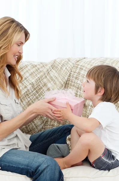 Mother offering present to her son — Stock Photo, Image