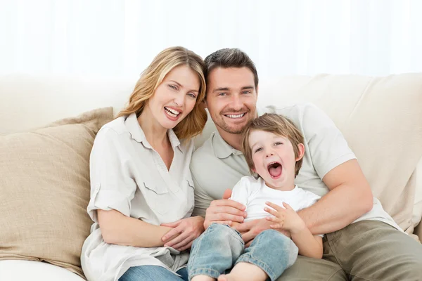 Família feliz em seu sofá — Fotografia de Stock