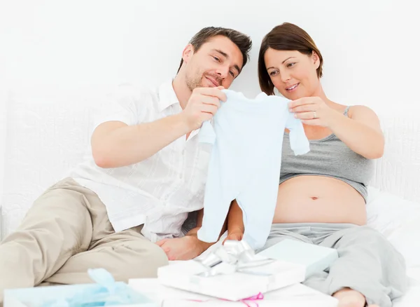 Young futur parents with chlidrens clothes — Stock Photo, Image