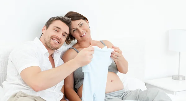 Young futur parents with chlidrens clothes — Stock Photo, Image