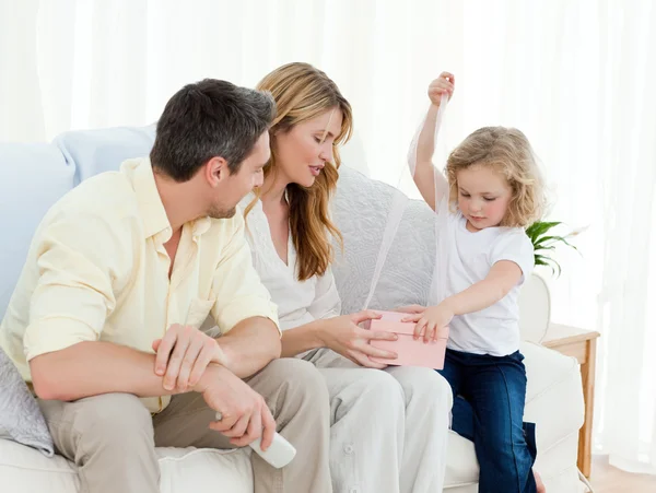 Parents offering a gift to her daughter — Stock Photo, Image