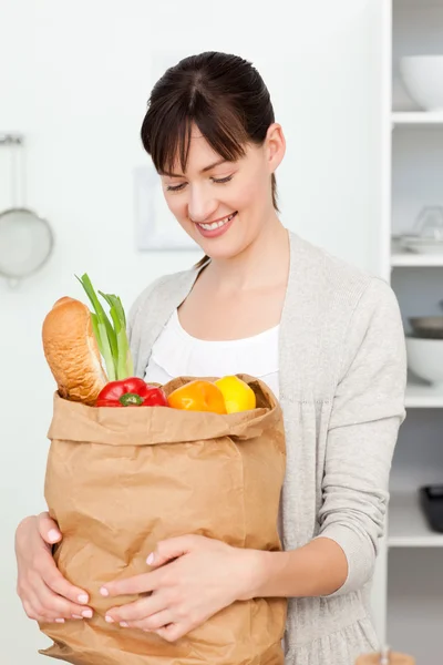 Mulher com sacos de compras na cozinha — Fotografia de Stock