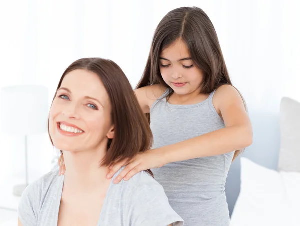 Lovely daughter brushing her woman hairs at home — Stock Photo, Image