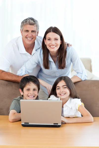 Glada familjen tittar på kameran — Stockfoto