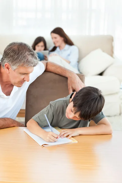 Ojciec pomaga synowi w zadaniach domowych. — Zdjęcie stockowe