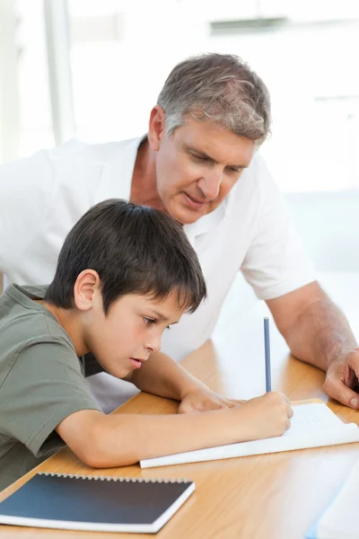 Apa segít a fiának a házi feladatában. — Stock Fotó