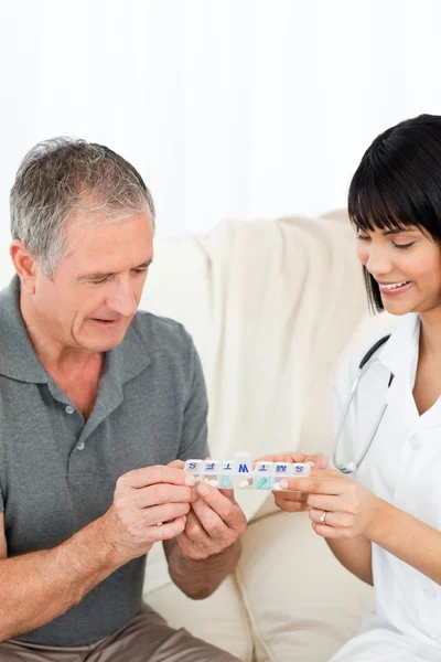 Nurse showing pills to her patient — Stock Photo, Image