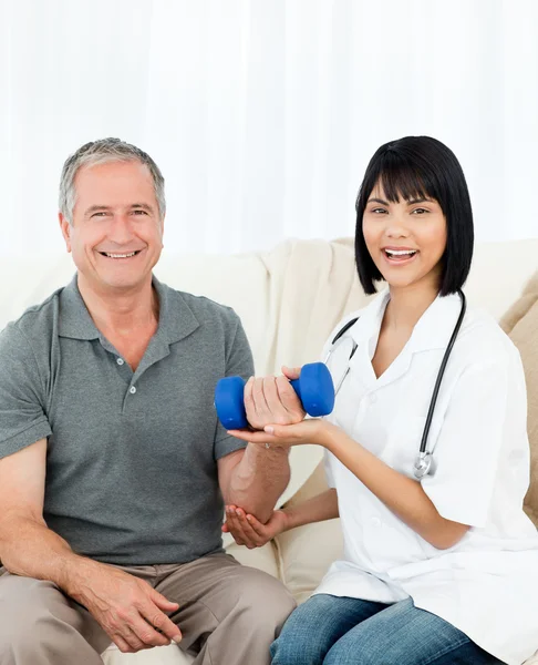 Nurse helping her patient to do exercises — Stock Photo, Image