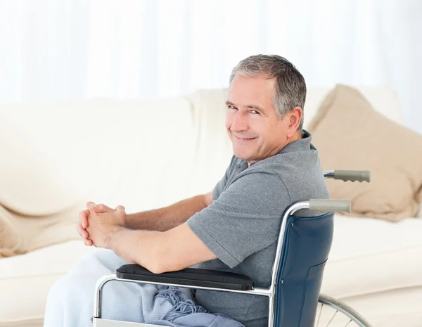 Volwassen man in zijn rolstoel te kijken naar de camera — Stockfoto