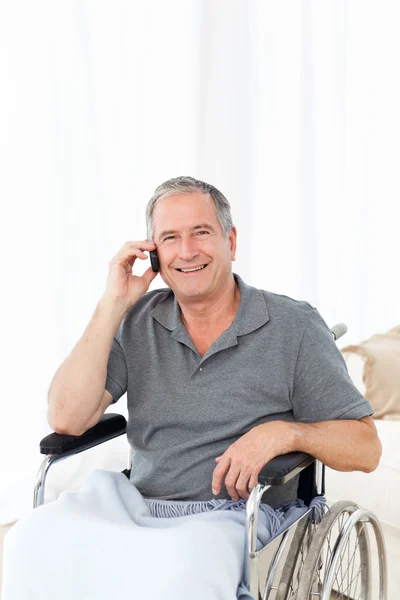 Senior in his wheelchair phoning — Stock Photo, Image
