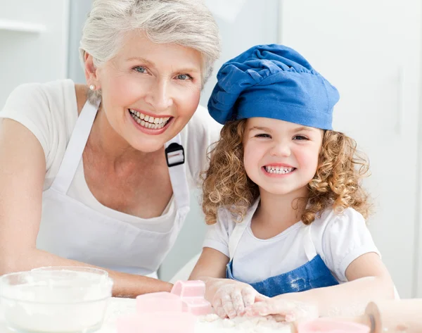 A little girl with her grandmother looking at the camera — Stock Photo, Image