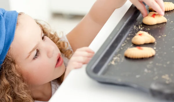 Little girl stealing cookies — Stock Photo, Image