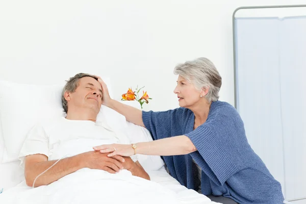 Mature woman taking care of her husband — Stock Photo, Image