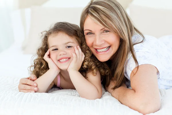 Little girl with her grandmother looking at the camera — Stock Photo, Image